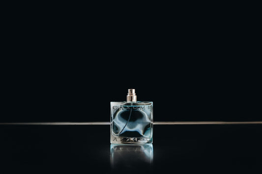 Sport — clear glass fragrance bottle on dark surface
